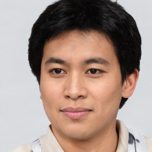 Joyful asian young-adult male with short  brown hair and brown eyes