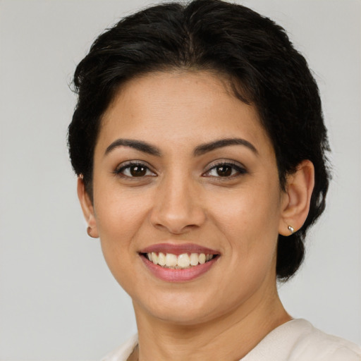 Joyful latino young-adult female with short  brown hair and brown eyes