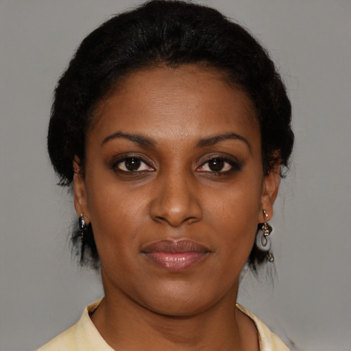 Joyful black young-adult female with medium  brown hair and brown eyes