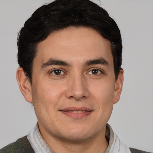 Joyful white adult male with short  brown hair and brown eyes