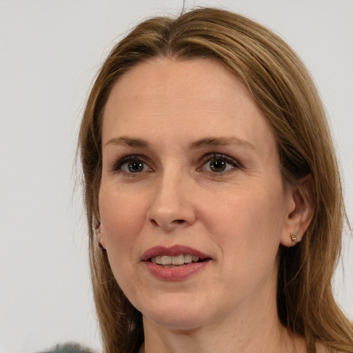 Joyful white adult female with long  brown hair and brown eyes