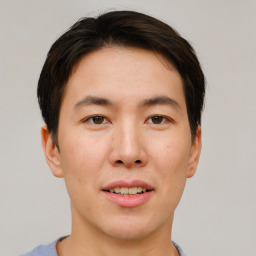 Joyful asian young-adult male with short  brown hair and brown eyes