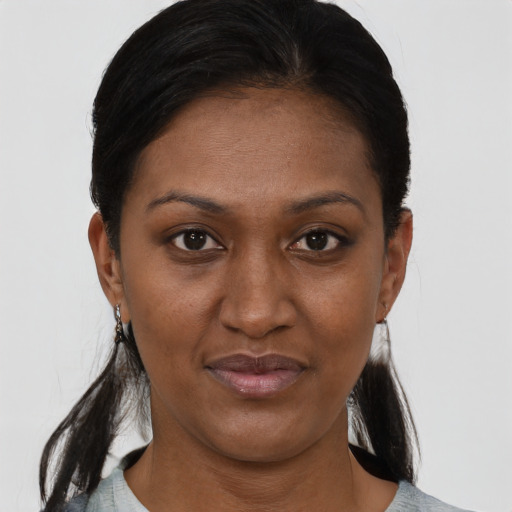 Joyful black young-adult female with short  brown hair and brown eyes