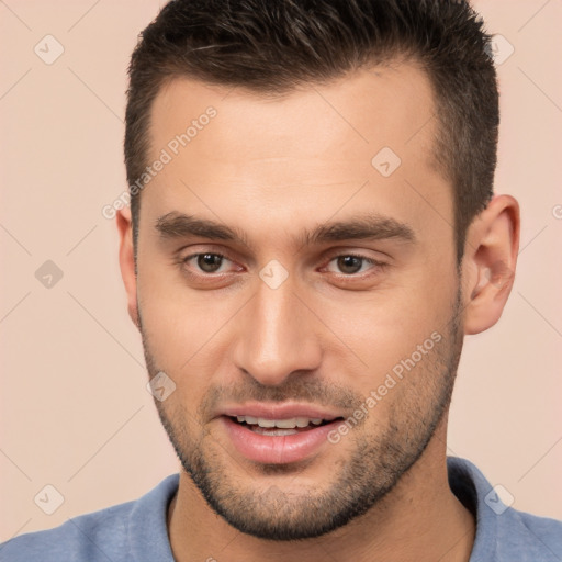 Joyful white young-adult male with short  brown hair and brown eyes