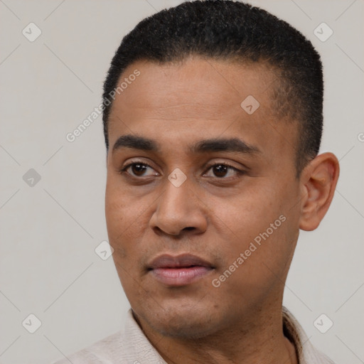 Joyful latino young-adult male with short  black hair and brown eyes