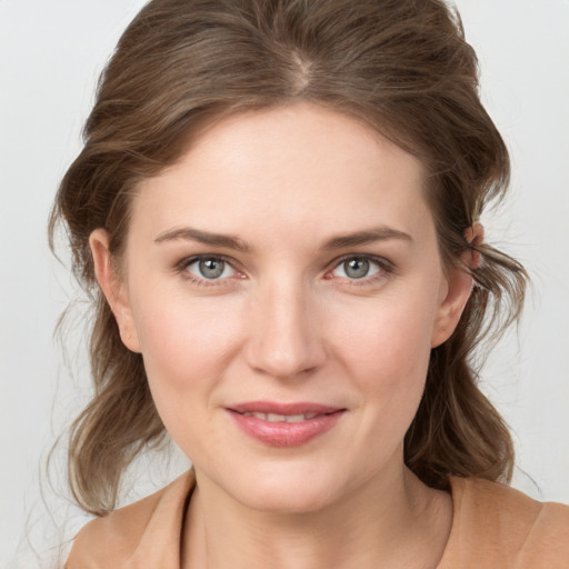 Joyful white young-adult female with medium  brown hair and grey eyes