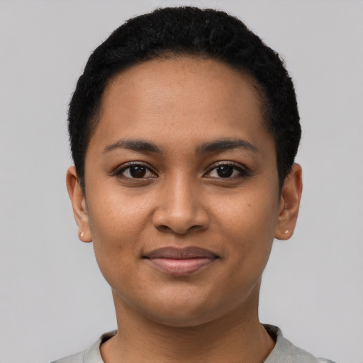 Joyful latino young-adult female with short  black hair and brown eyes