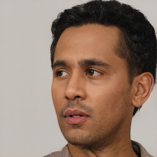 Neutral latino young-adult male with short  black hair and brown eyes