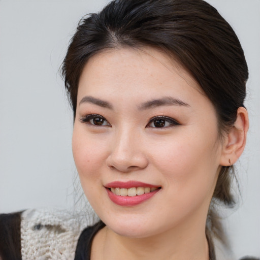 Joyful asian young-adult female with medium  brown hair and brown eyes
