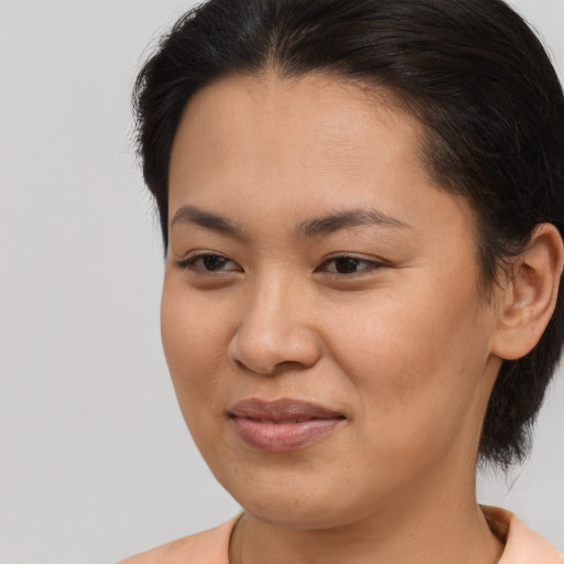 Joyful asian young-adult female with medium  brown hair and brown eyes