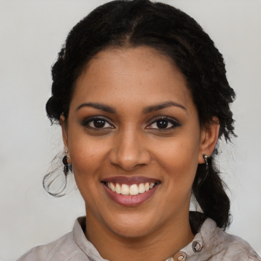 Joyful black young-adult female with medium  black hair and brown eyes
