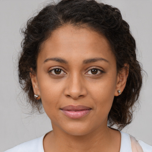 Joyful latino young-adult female with medium  brown hair and brown eyes