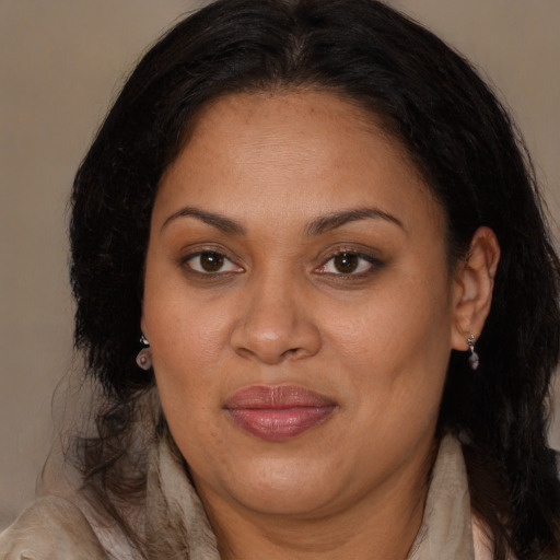 Joyful latino adult female with long  brown hair and brown eyes