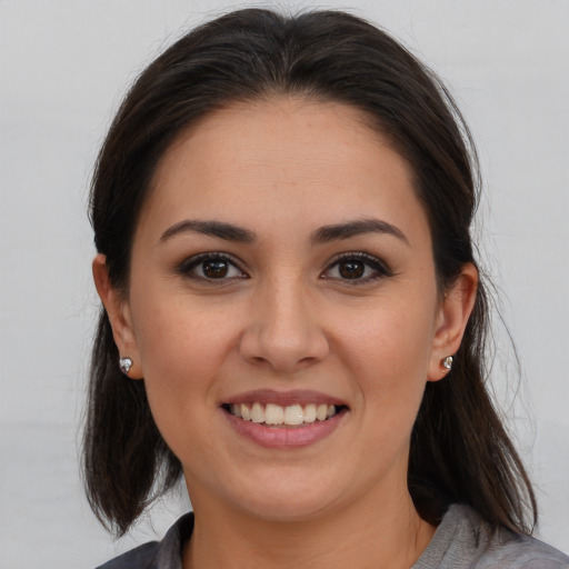 Joyful white young-adult female with medium  brown hair and brown eyes