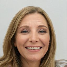 Joyful white young-adult female with long  brown hair and blue eyes