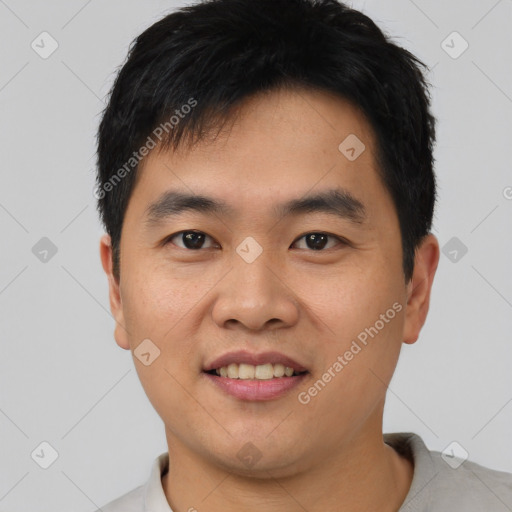 Joyful asian young-adult male with short  black hair and brown eyes