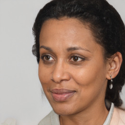 Joyful black adult female with medium  brown hair and brown eyes