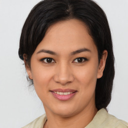 Joyful latino young-adult female with medium  brown hair and brown eyes