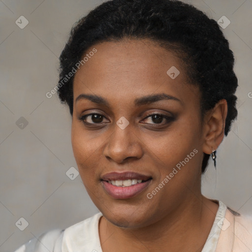 Joyful black young-adult female with short  black hair and brown eyes