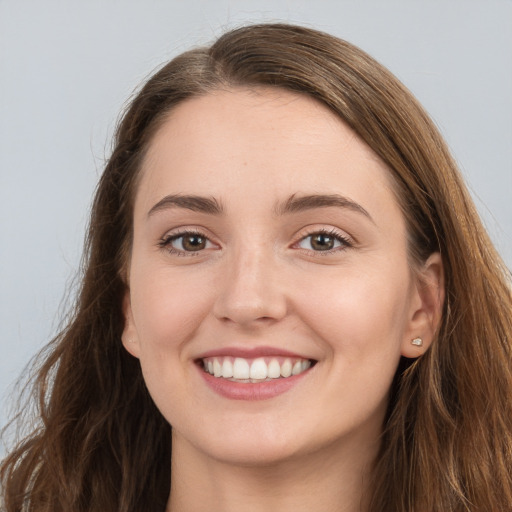 Joyful white young-adult female with long  brown hair and grey eyes