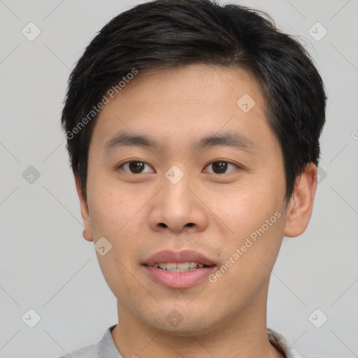 Joyful asian young-adult male with short  brown hair and brown eyes