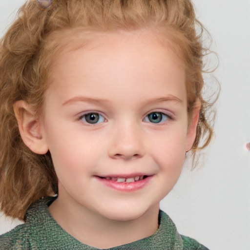 Joyful white child female with short  brown hair and blue eyes