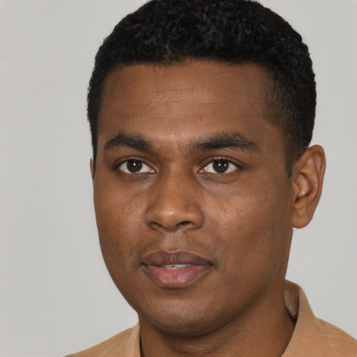 Joyful black young-adult male with short  black hair and brown eyes