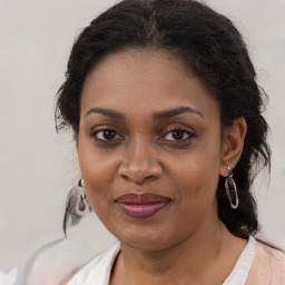 Joyful black young-adult female with medium  brown hair and brown eyes