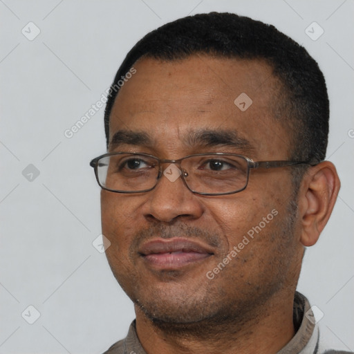Joyful latino adult male with short  black hair and brown eyes