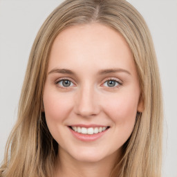 Joyful white young-adult female with long  brown hair and green eyes