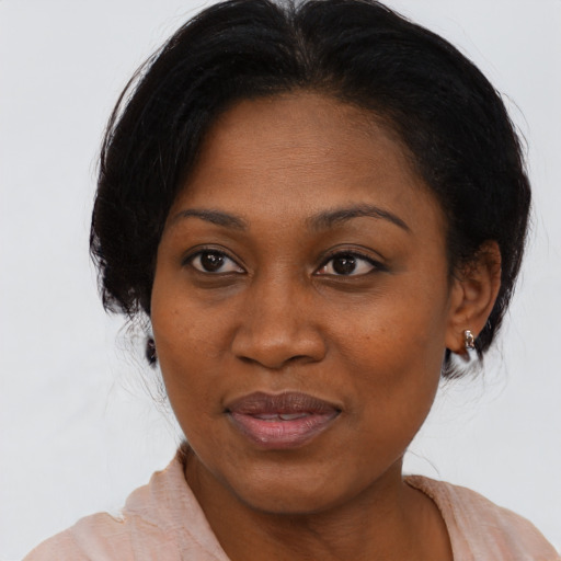 Joyful black adult female with medium  brown hair and brown eyes