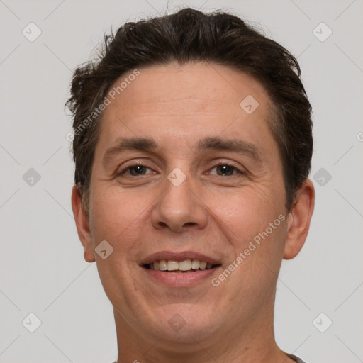 Joyful white adult male with short  brown hair and brown eyes