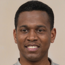 Joyful black young-adult male with short  black hair and brown eyes