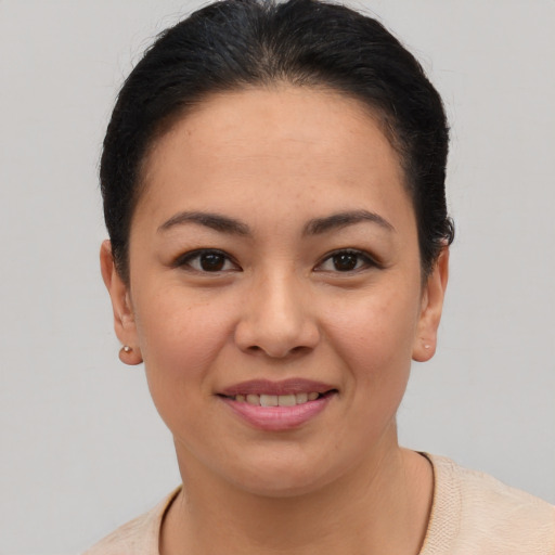 Joyful asian young-adult female with short  brown hair and brown eyes