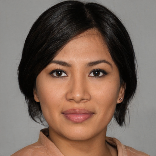 Joyful asian young-adult female with medium  brown hair and brown eyes