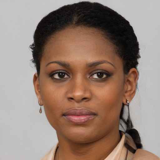 Joyful black young-adult female with short  brown hair and brown eyes