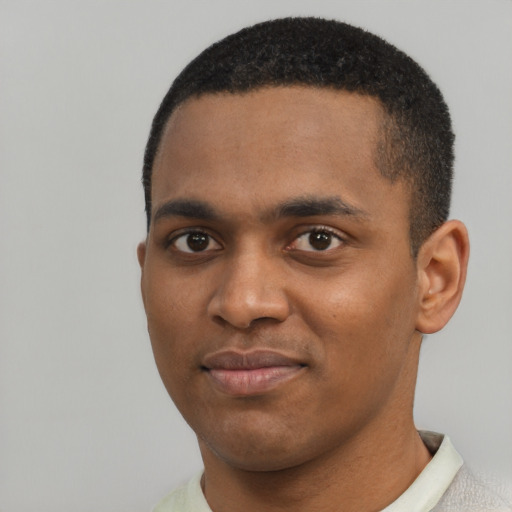 Joyful black young-adult male with short  black hair and brown eyes