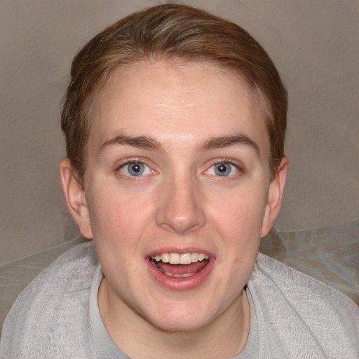 Joyful white young-adult female with short  brown hair and blue eyes