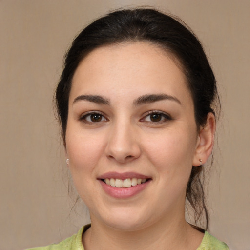 Joyful white young-adult female with medium  brown hair and brown eyes