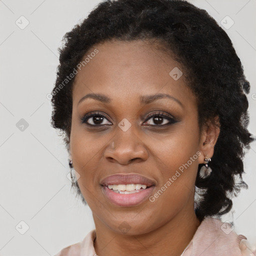 Joyful black adult female with short  brown hair and brown eyes