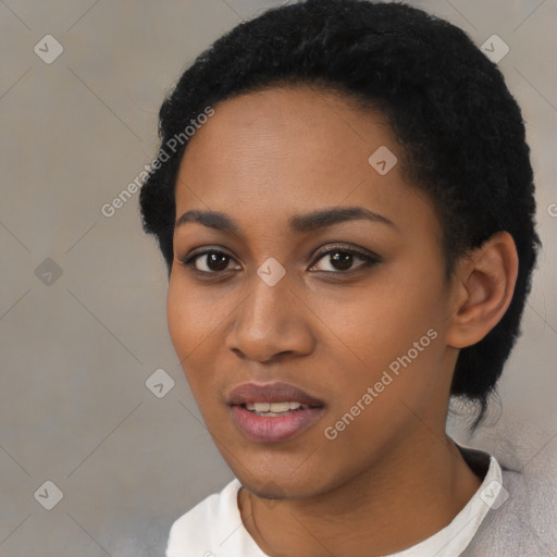 Joyful black young-adult female with short  black hair and brown eyes