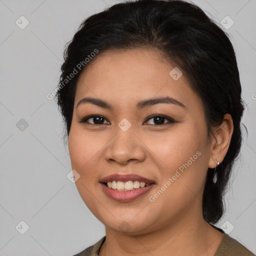 Joyful latino young-adult female with long  brown hair and brown eyes