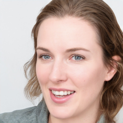 Joyful white young-adult female with medium  brown hair and blue eyes