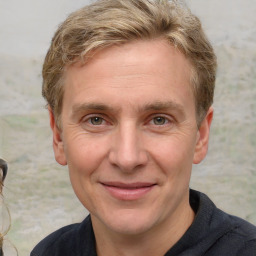 Joyful white adult male with short  brown hair and grey eyes