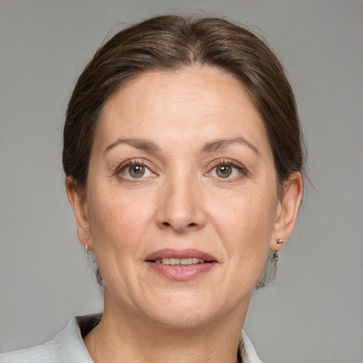 Joyful white adult female with medium  brown hair and grey eyes