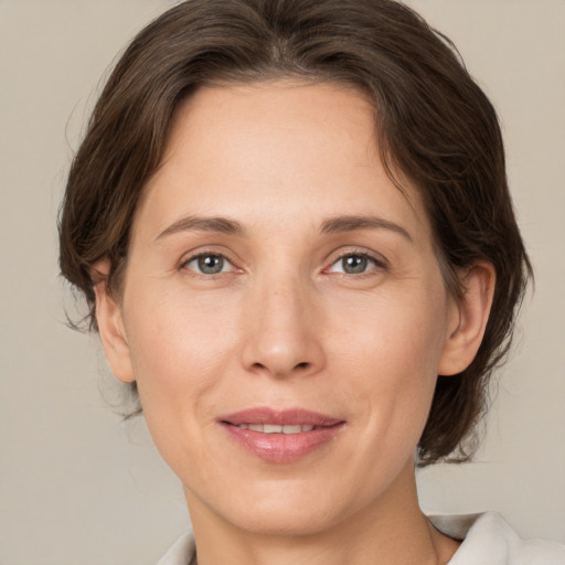 Joyful white adult female with medium  brown hair and brown eyes