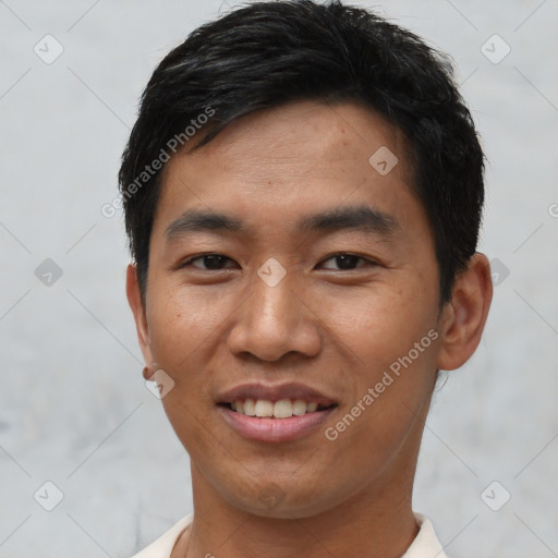 Joyful asian young-adult male with short  black hair and brown eyes