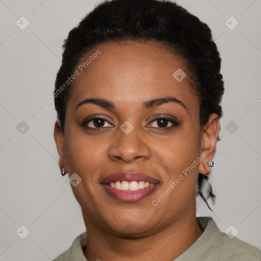 Joyful black young-adult female with short  black hair and brown eyes