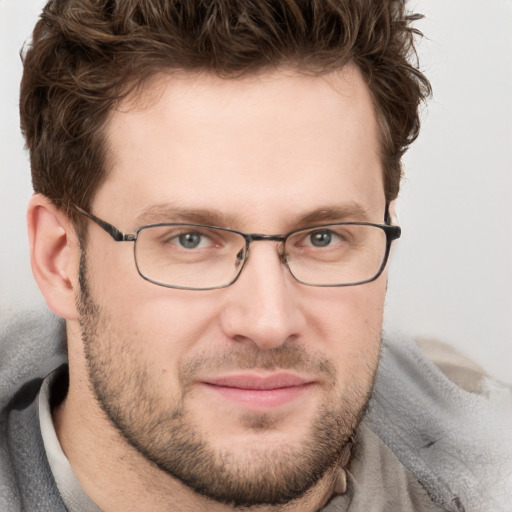 Joyful white adult male with short  brown hair and blue eyes