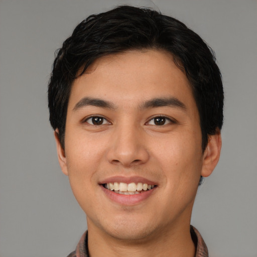 Joyful asian young-adult male with short  black hair and brown eyes